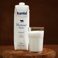 Itambé natural milk carton and glass on a wooden surface with a brown background